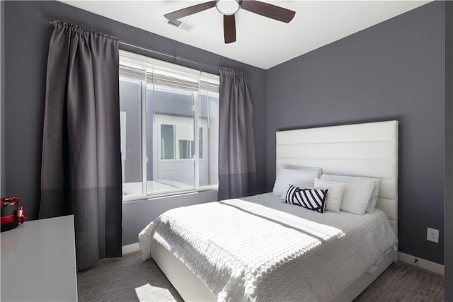 bedroom with carpet flooring, a ceiling fan, baseboards, and visible vents