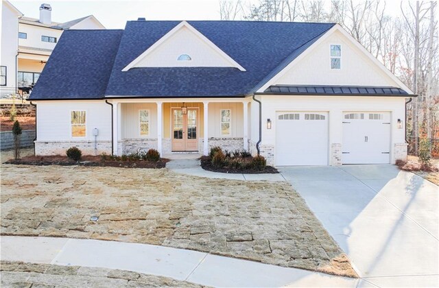 view of front facade with a porch, a garage, and a front yard