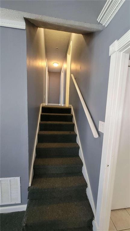 stairs with tile patterned flooring