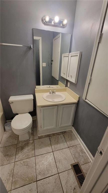 bathroom featuring vanity, toilet, and tile patterned floors