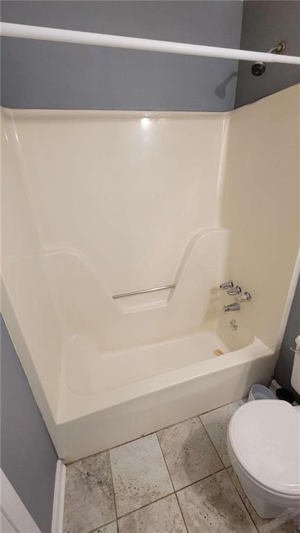 bathroom with bathtub / shower combination, tile patterned floors, and toilet