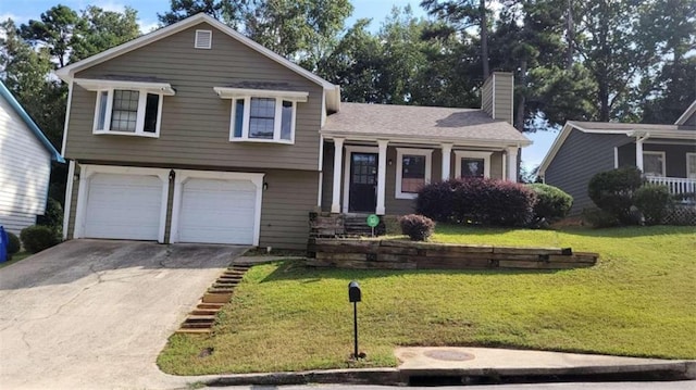 split level home featuring a garage and a front lawn