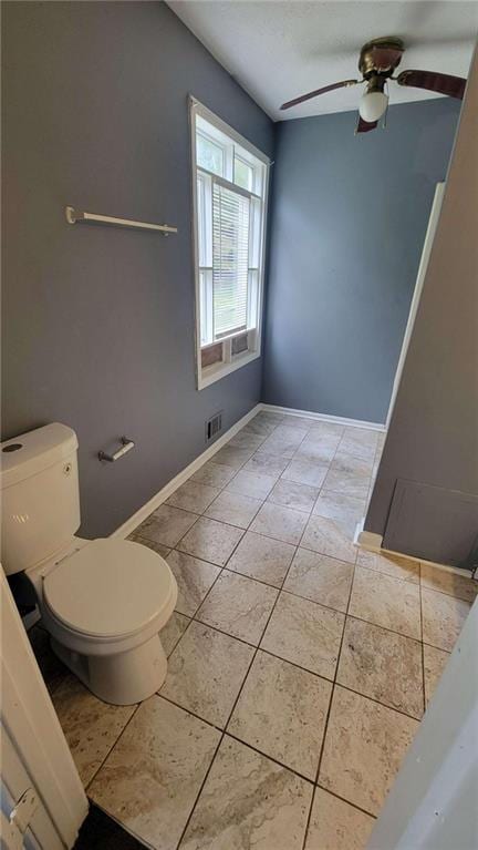 bathroom featuring toilet, ceiling fan, and tile patterned floors