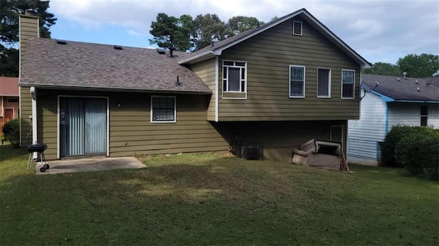 back of house with a lawn