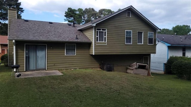 back of property with a lawn and a patio