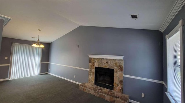 unfurnished living room featuring a chandelier, vaulted ceiling, a fireplace, carpet, and ornamental molding