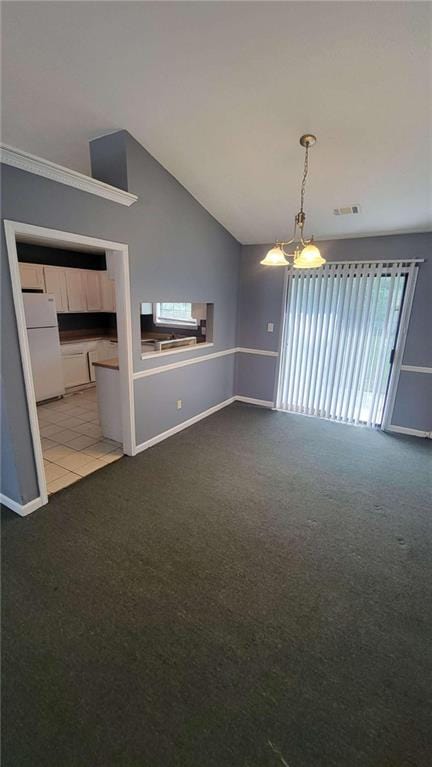 unfurnished living room with a notable chandelier, lofted ceiling, and carpet flooring