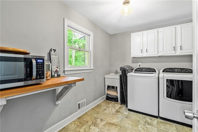 135 Crimson Rdg, Tyrone, GA 30290 - laundry area with cabinet space, washing machine and clothes dryer, and baseboards