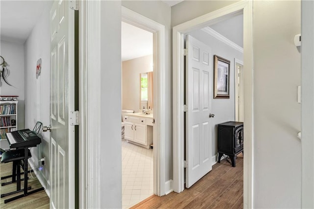 135 Crimson Rdg, Tyrone, GA 30290 - corridor with light wood-style flooring, ornamental molding, and a sink