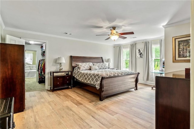 135 Crimson Rdg, Tyrone, GA 30290 - bedroom featuring light wood-style flooring, ornamental molding, a walk in closet, ceiling fan, and baseboards