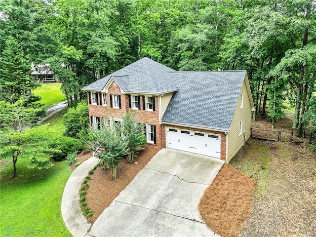 135 Crimson Rdg, Tyrone, GA 30290 - colonial inspired home with a shingled roof, concrete driveway, brick siding, an attached garage, and a forest view