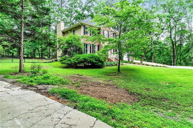 135 Crimson Rdg, Tyrone, GA 30290 - view of home's exterior featuring a chimney and a yard