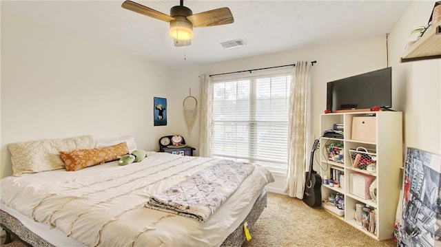 bedroom with ceiling fan and light colored carpet