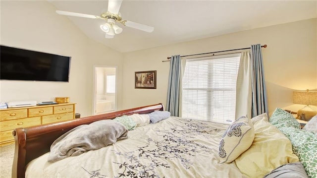 bedroom with vaulted ceiling, carpet flooring, connected bathroom, and ceiling fan