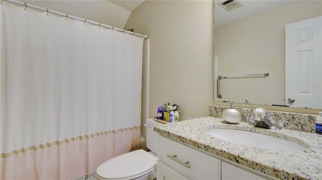 bathroom featuring vanity, vaulted ceiling, curtained shower, and toilet