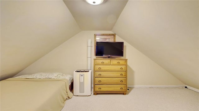 bedroom with lofted ceiling and light carpet