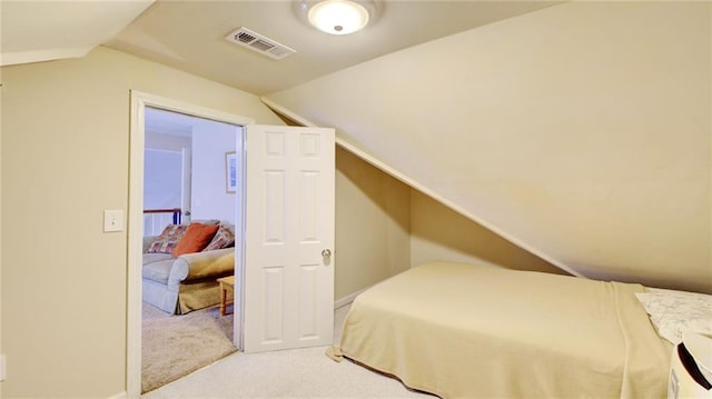 carpeted bedroom featuring vaulted ceiling