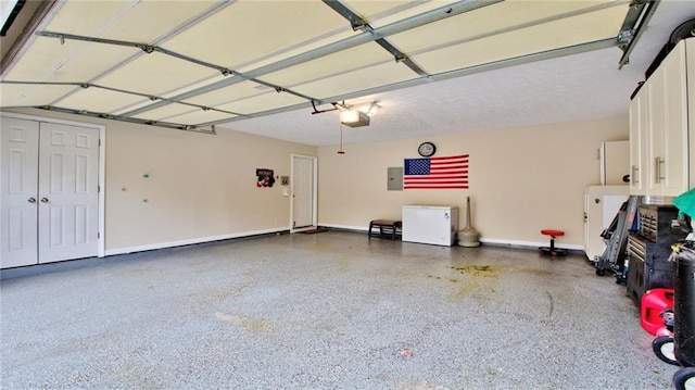 garage featuring a garage door opener and electric panel