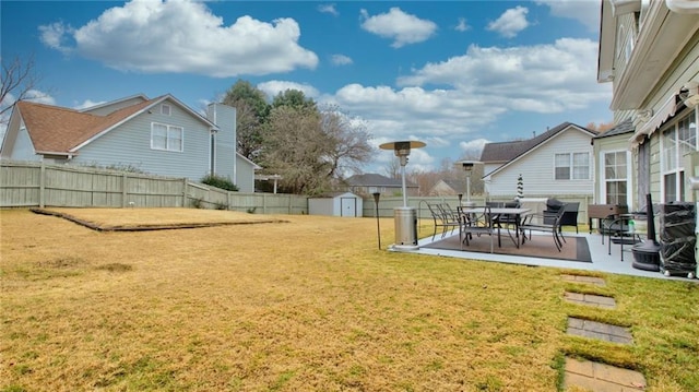view of yard featuring a patio area and a storage unit