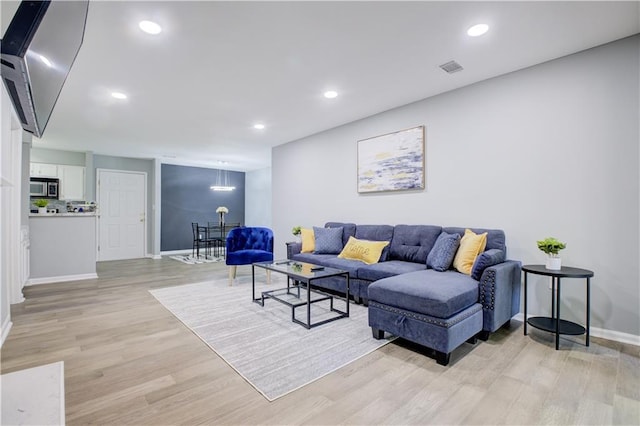 living room with light hardwood / wood-style floors