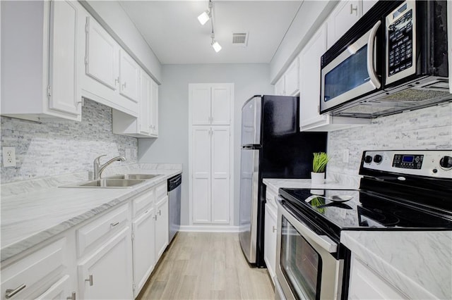 kitchen featuring sink, light wood-type flooring, white cabinets, and appliances with stainless steel finishes