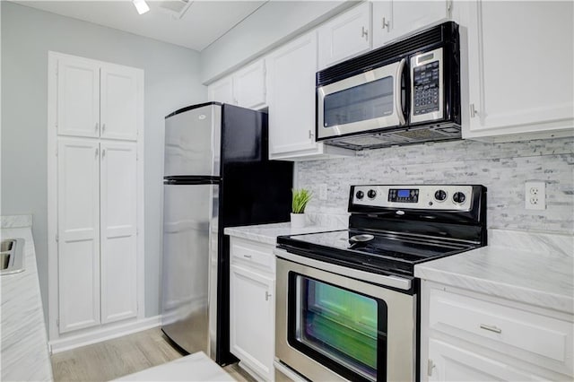 kitchen featuring white cabinetry, tasteful backsplash, and appliances with stainless steel finishes