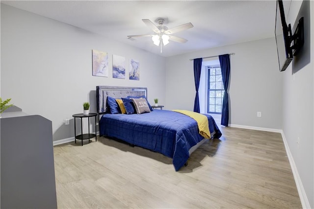 bedroom with ceiling fan and light hardwood / wood-style floors