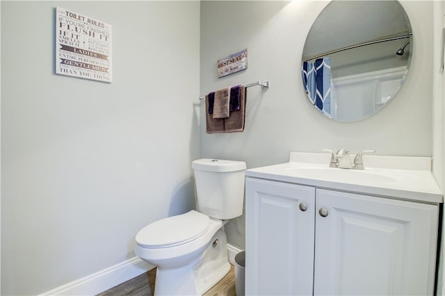 bathroom featuring vanity, hardwood / wood-style floors, and toilet