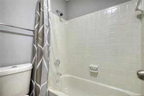 bathroom featuring toilet and shower / bath combo