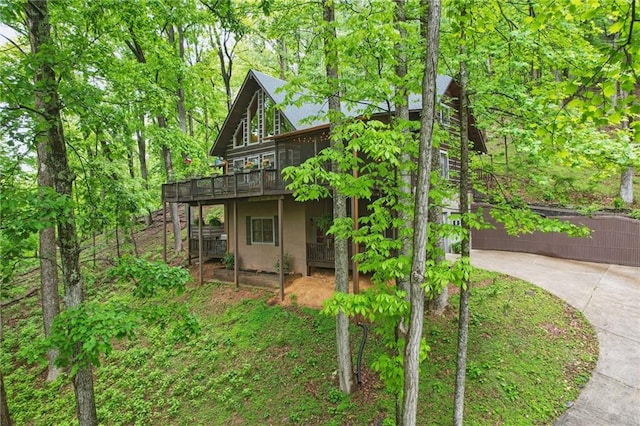 view of home's exterior with stucco siding and a deck