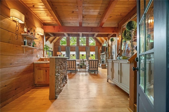 interior space with french doors, wooden ceiling, lofted ceiling with beams, wooden walls, and light wood-style floors