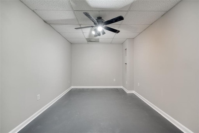 empty room featuring a drop ceiling and ceiling fan