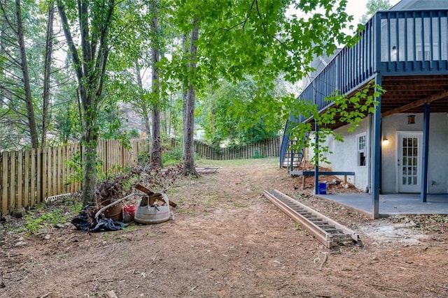 view of yard with a deck and a patio