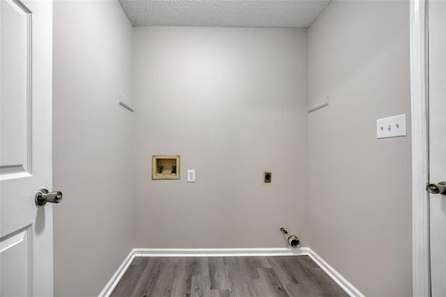 laundry area with hookup for an electric dryer, hardwood / wood-style floors, hookup for a gas dryer, and washer hookup