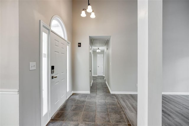 entrance foyer featuring a towering ceiling and dark hardwood / wood-style floors