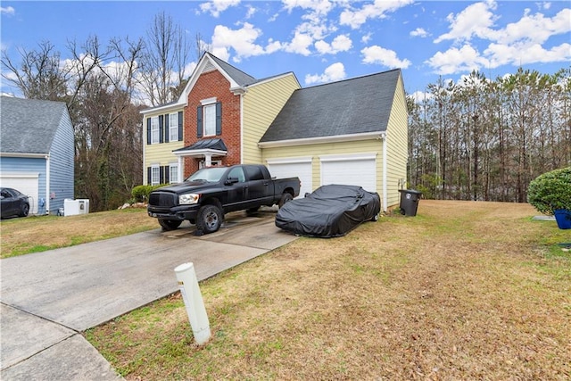 view of side of home featuring driveway, a garage, roof with shingles, a yard, and brick siding