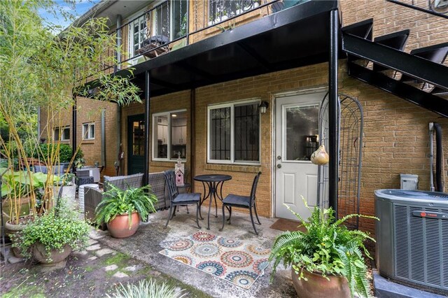 148 Waverly Way Unit 10, Atlanta, GA 30307 - back of house with central air condition unit, brick siding, and a patio area