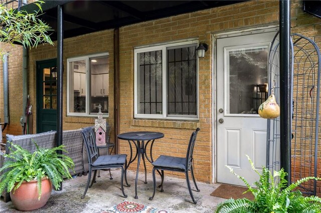 148 Waverly Way Unit 10, Atlanta, GA 30307 - view of exterior entry featuring brick siding and a patio area
