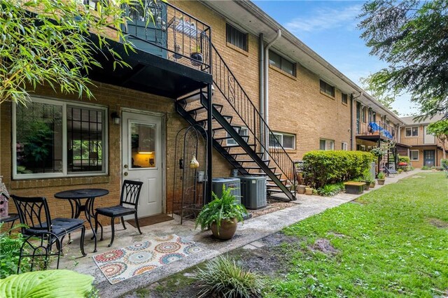 148 Waverly Way Unit 10, Atlanta, GA 30307 - back of property with stairs, central AC unit, a yard, and brick siding