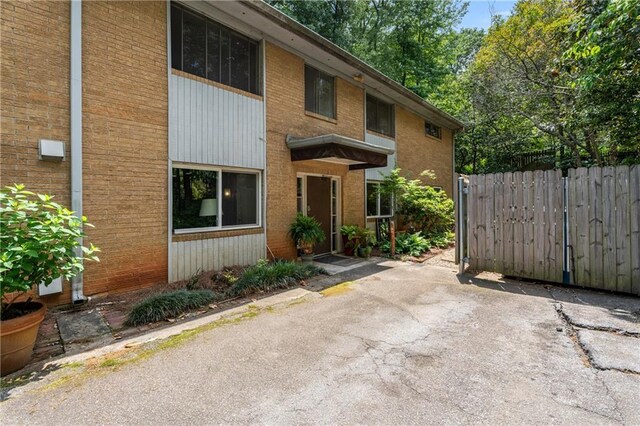 148 Waverly Way Unit 10, Atlanta, GA 30307 - view of front of house featuring fence, a patio area, and brick siding