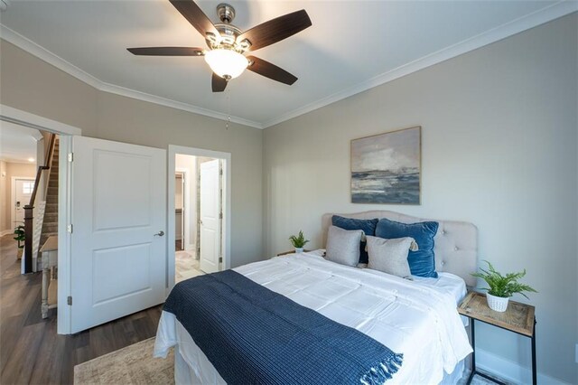 bedroom with ceiling fan, crown molding, and dark wood-type flooring