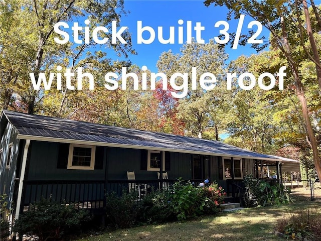 rear view of property featuring metal roof