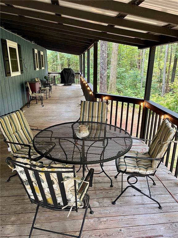 deck with outdoor dining area