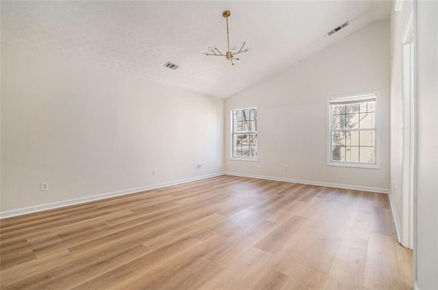 unfurnished room featuring light wood-type flooring, visible vents, and baseboards