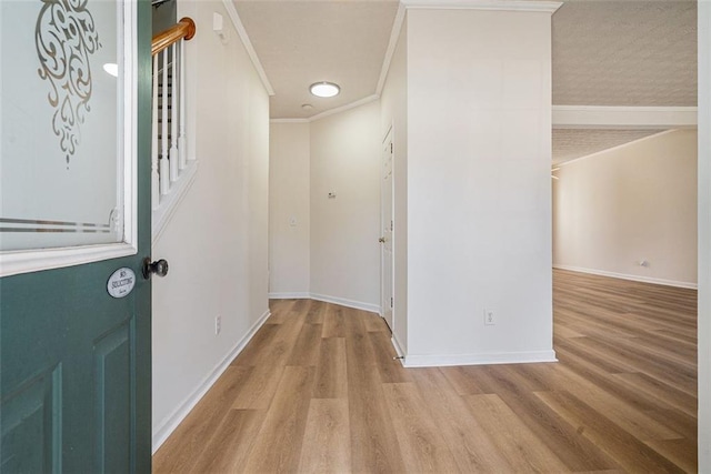 foyer with ornamental molding, stairs, baseboards, and wood finished floors