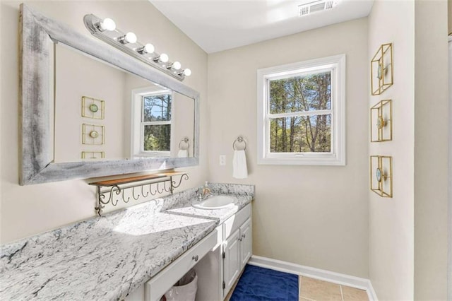 bathroom featuring vanity, baseboards, visible vents, and tile patterned flooring