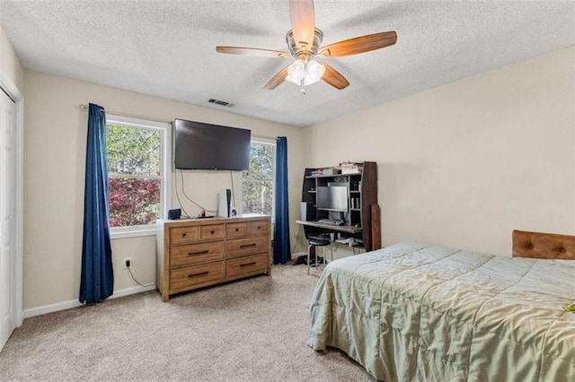 bedroom featuring visible vents, a textured ceiling, baseboards, and a ceiling fan