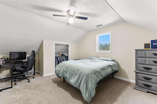 bedroom featuring baseboards, carpet floors, visible vents, and vaulted ceiling