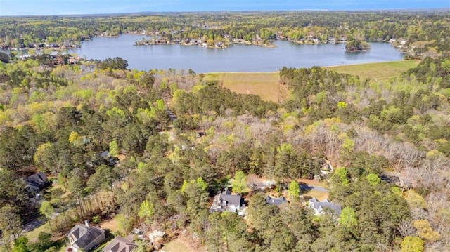 bird's eye view featuring a forest view and a water view