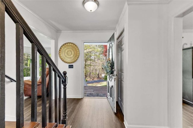 foyer with stairway, crown molding, and wood finished floors